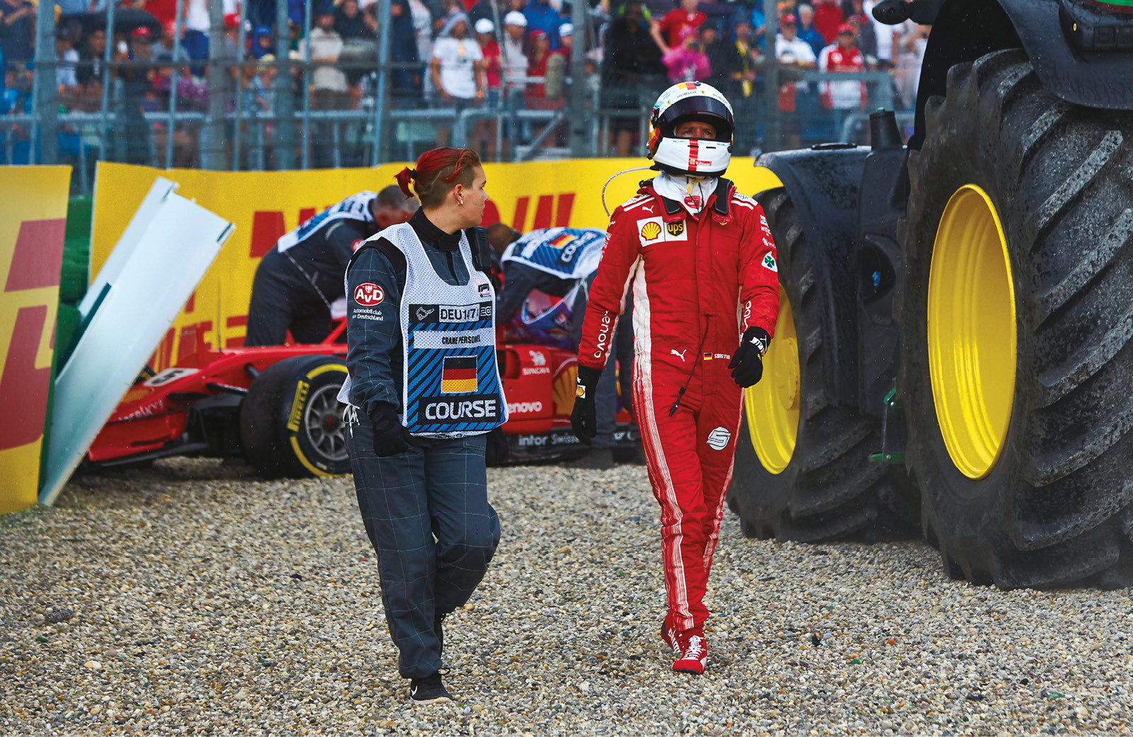 An emotional Vettel trudges away from his Ferrari after his costly error in Germany