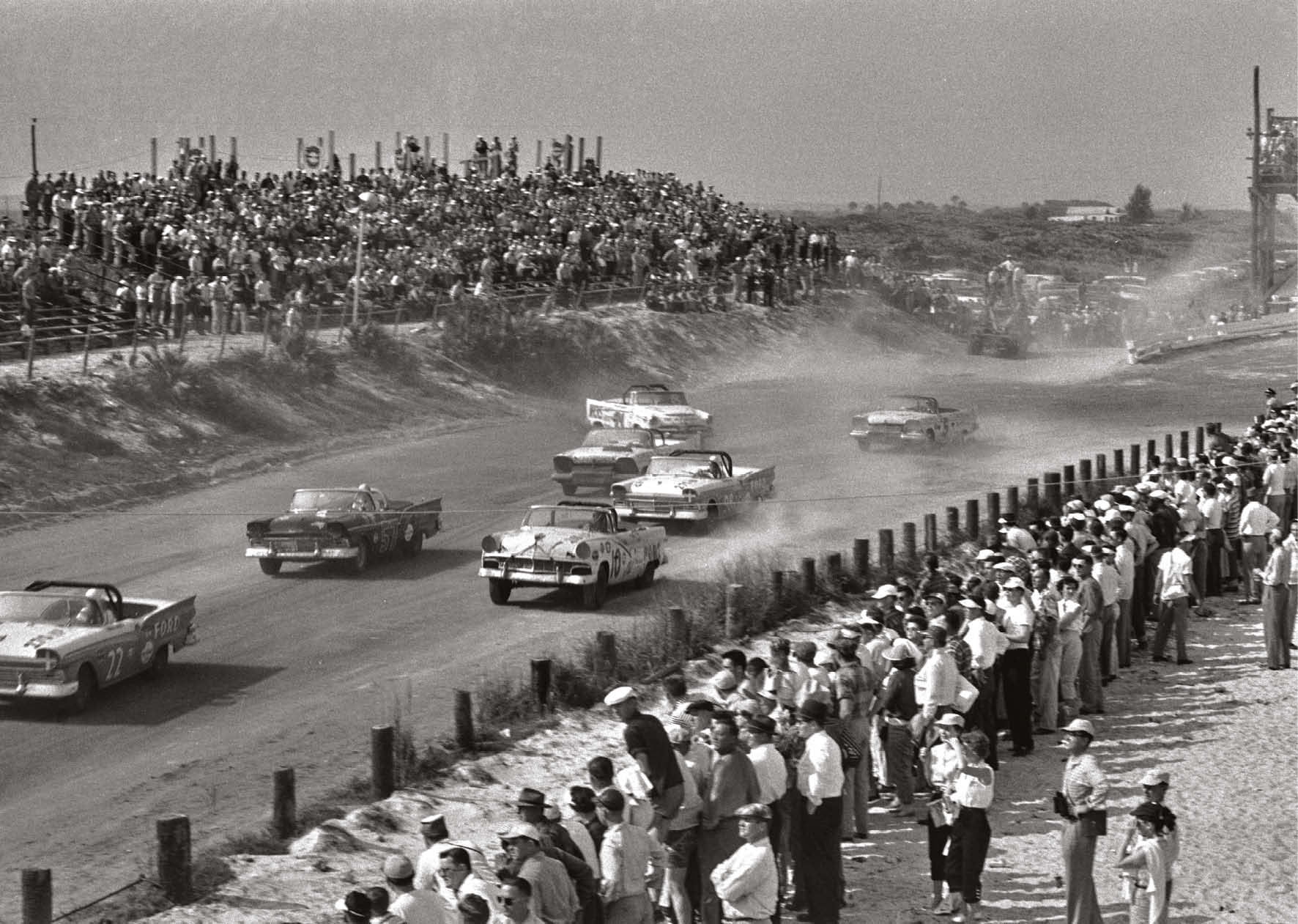 The pack roars away for a convertible race as big crowds watch on.