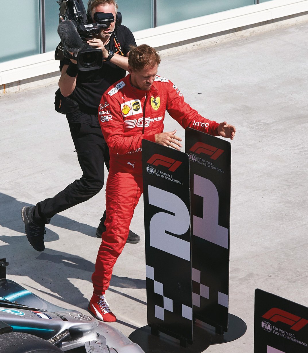 An irate Vettel plays to the crowd by swapping the number boards under the podium in Canada