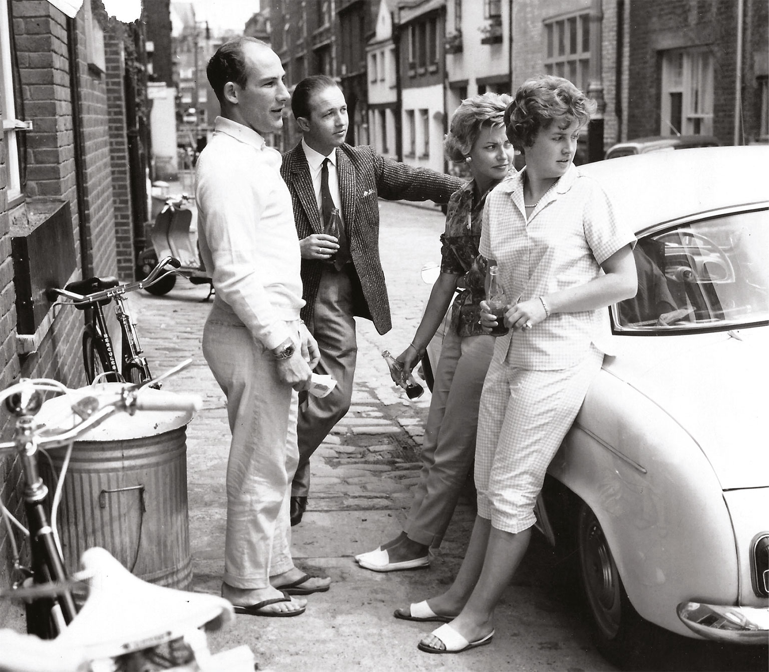 Stirling and Val (in the foreground) about to visit their Belgravia local. The bikes are to exercise Moss’s legs after his 1960 Spa accident