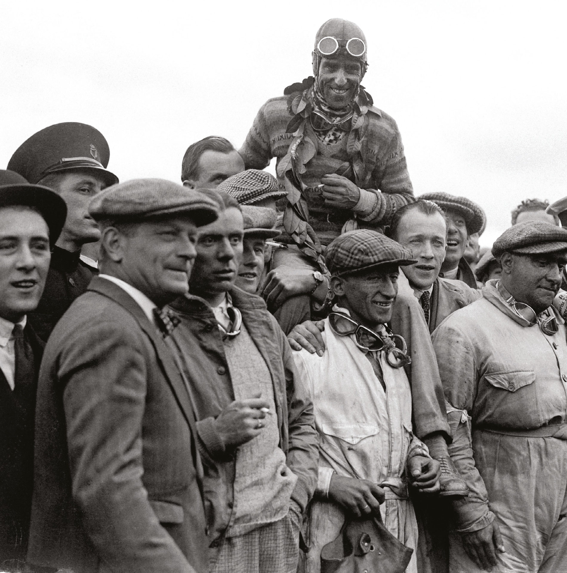 Nuvolari hoisted aloft by his Alfa team